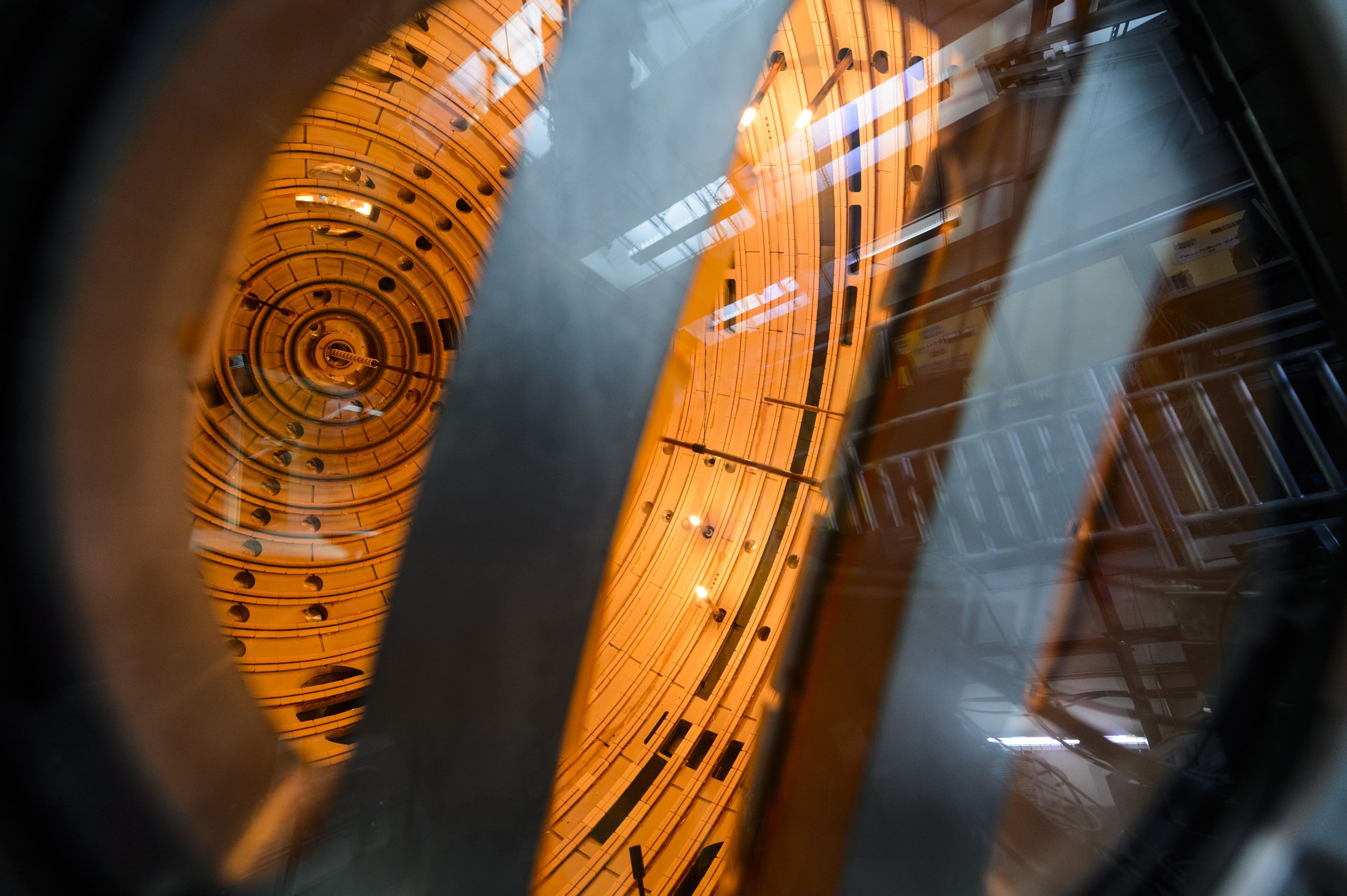 a large, spherical piece of scientific equipment with glowing orange lights and silver metal braces