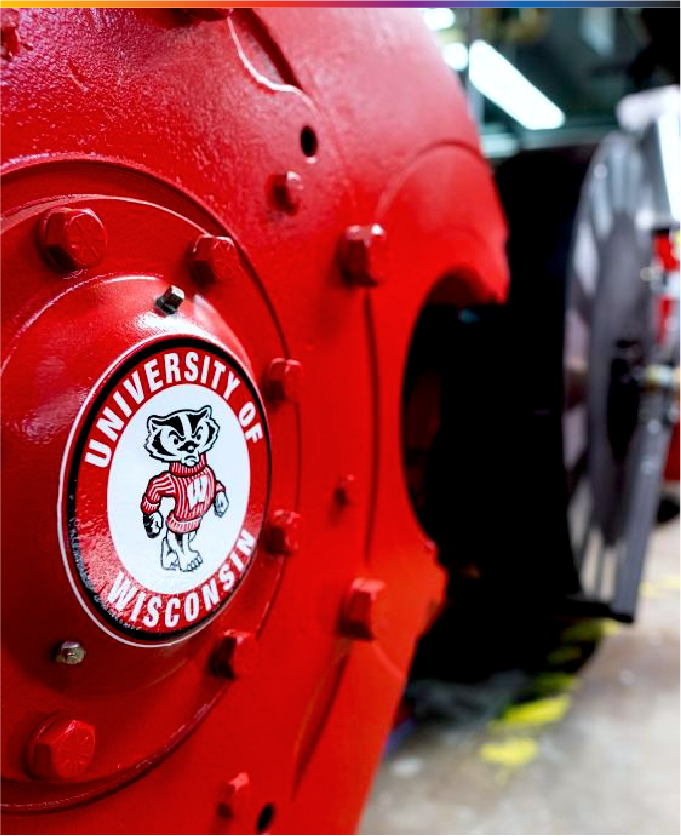 Large piece of red metal with UW-Madison badger logo and the text "University of Wisconsin."
