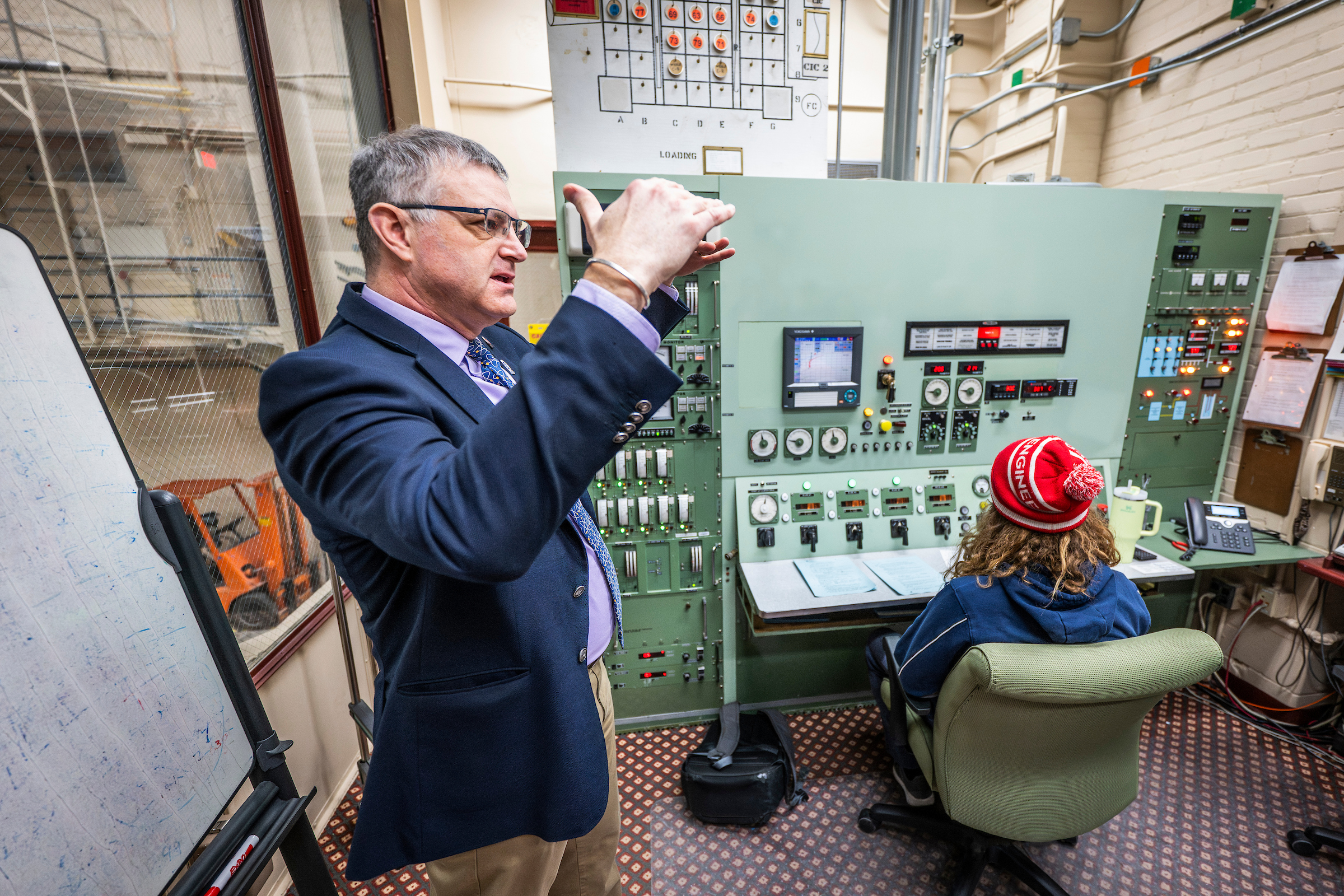 person gesturing to a group of people off camera