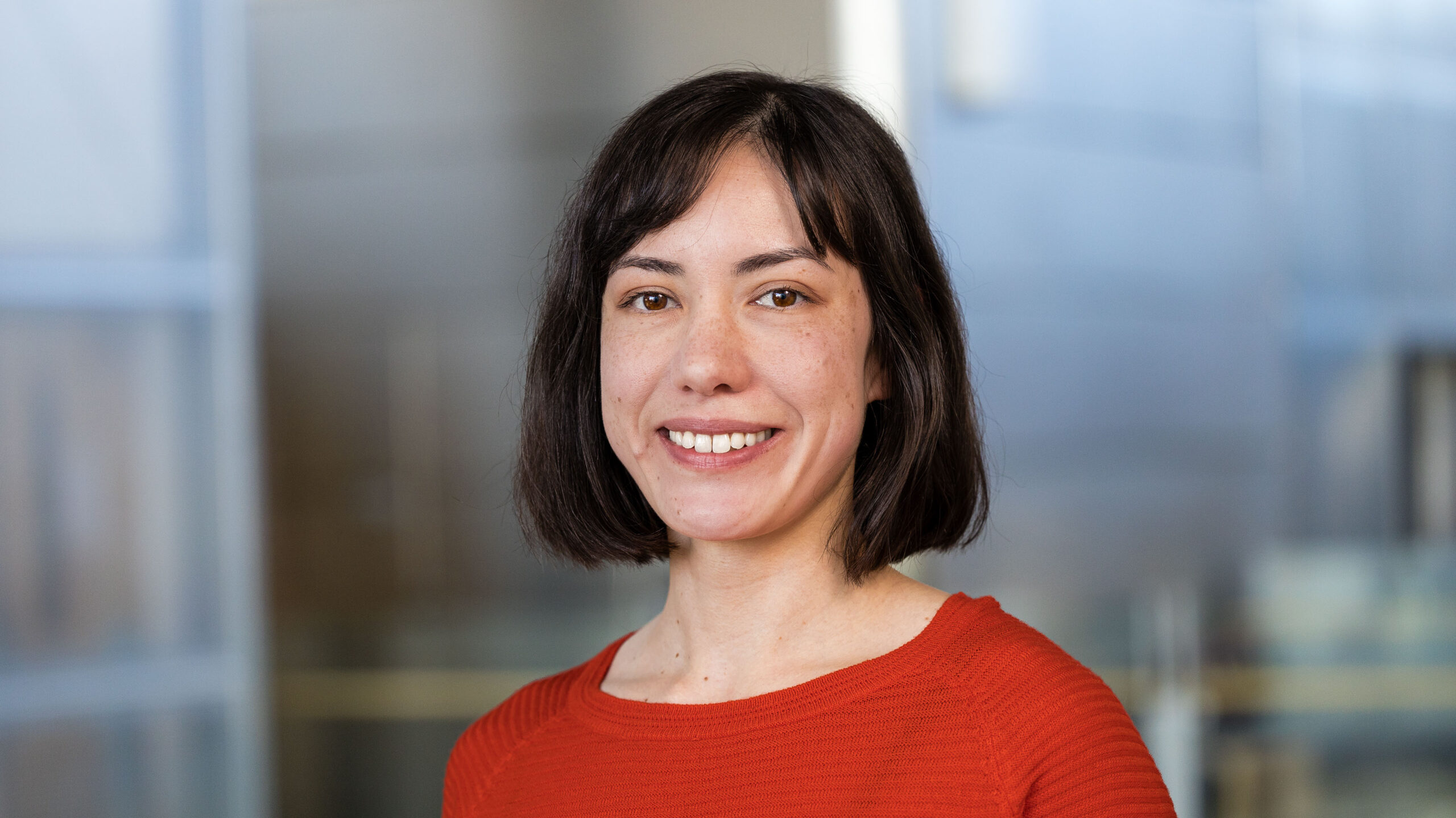 headshot of woman with light skin and dark brown hair